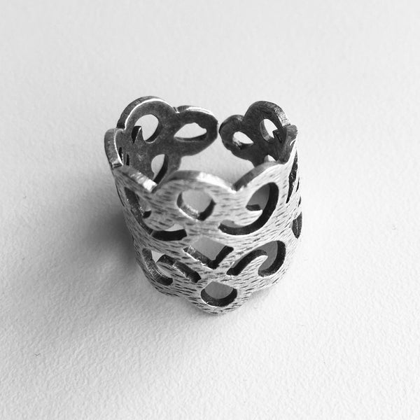 top close up view of  Delicate ,Regal ,Lacy Cut Out Design, with an adjustable ring band, Made in Turkey with mixed metals, and Nickle free.  Starts at ring size 6.5 and lets you increase the size to fit your most curviest of fingers. 3/4 of an inch tall, but high in sweet lacy style. Unique Jewelry lightweight and imported.  Made in Turkey and adjustable.     Zamac, metal and Nickle free.