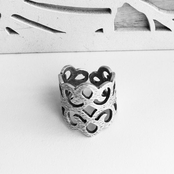 top front view of  Delicate ,Regal ,Lacy Cut Out Design, with an adjustable ring band, Made in Turkey with mixed metals, and Nickle free.  Starts at ring size 6.5 and lets you increase the size to fit your most curviest of fingers. 3/4 of an inch tall, but high in sweet lacy style. Unique Jewelry lightweight and imported.  Made in Turkey and adjustable.     Zamac, metal and Nickle free.