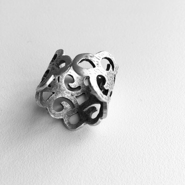 back side view with adjustable band featured of  Delicate ,Regal ,Lacy Cut Out Design, with an adjustable ring band, Made in Turkey with mixed metals, and Nickle free.  Starts at ring size 6.5 and lets you increase the size to fit your most curviest of fingers. 3/4 of an inch tall, but high in sweet lacy style. Unique Jewelry lightweight and imported.  Made in Turkey and adjustable.     Zamac, metal and Nickle free.