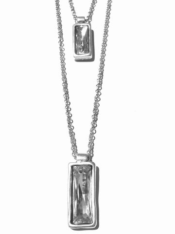 Silver double metail chain link necklace with crystals embedded in a rectangle shaped pendant filled with a big chunck of clear crystal.  41 cm is the first chain with the second being about 61cm with a 5cm extend chain for added length.  Silver colored metal  necklace is very modern and a great statement piece. Jewlery made in Turkey just for us, and only limited quantities.  We offer free shipping and the best Turkish Jewlery, as shown in this photo