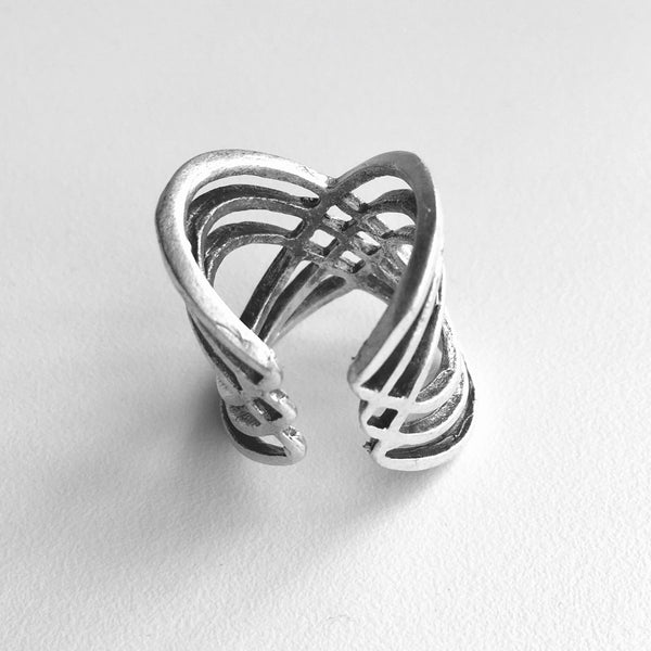 back view to see the adjustable band feature of our  Multi-cross mixed metal silver colored Turkish made ring with an adjustable band. Lightweight statement ring  with 1 inch height on the top wave, with a center half inch. A wave of bands with a woven 4 diamond shaped stamp in the middle.  Usual and Unique styled rings made just for you.